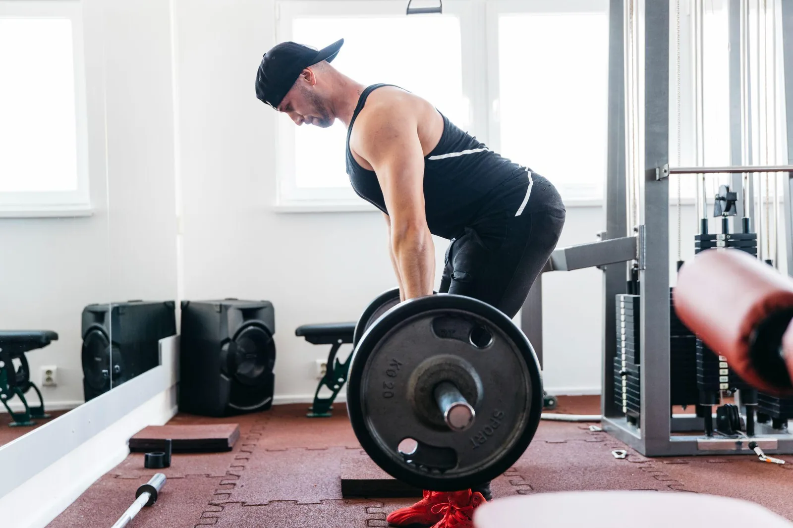 A lifter setting up for a barbell deadlift in a gym