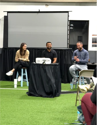 TJ speaking on a panel with two other presenters